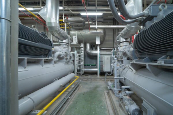 Inside of Industry factory. Chiller tower or cooling tower in building. System work machine. Condenser Water Supply and return pipe lines. Ventilation compressor. Water system in workshop.